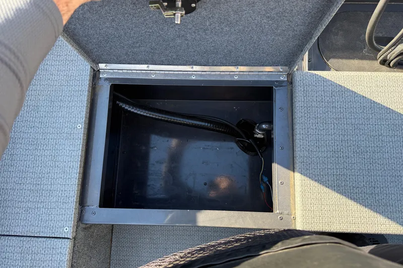 Slide: The Image of Open storage compartment in 2022 G3 Angler V17 T boat, showing interior wiring. - 25