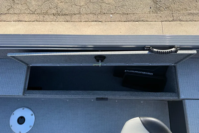 Slide: The Image of 2022 G3 Angler V17 T boat storage compartment with Humminbird equipment visible. - 26
