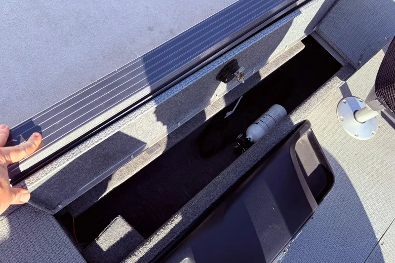 Slide: The Image of 2022 G3 Angler V17 T boat storage compartment with fire extinguisher and seat base. - 27