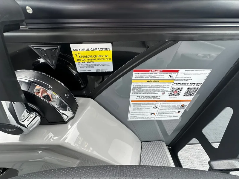 Slide: The Image of Trifecta 22 UL CS 2026 boat controls with safety and capacity labels. - 32