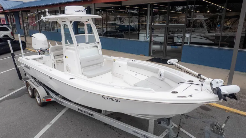 Slide: The Image of 2020 Everglades 243 Center Console boat on trailer outside store. - 3