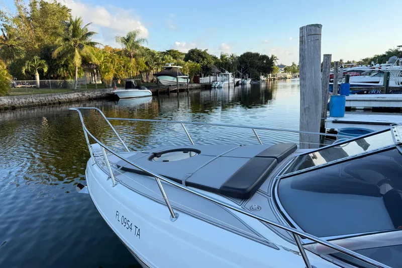 Slide: The Image of Schaefer 303 boat docked in a scenic marina, surrounded by lush greenery, 2021 model. - 16