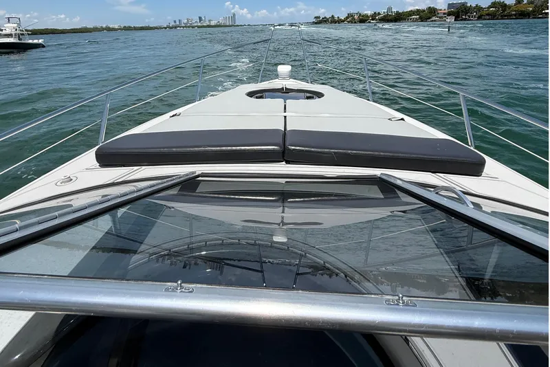 Slide: The Image of 2021 Schaefer 303 yacht cruising on a sunny day with city skyline in background. - 17