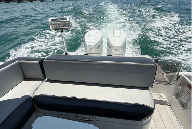 Slide: The Image of Schaefer 303 boat, 2021 model, cruising on open water with twin Mercury engines. - 18