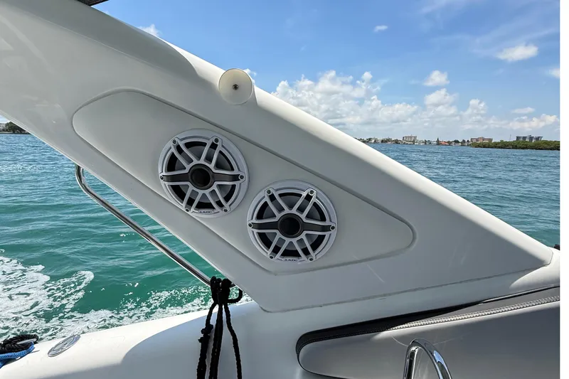 Slide: The Image of Boat speakers on a 2021 Schaefer 303, with ocean and cityscape in the background. - 21