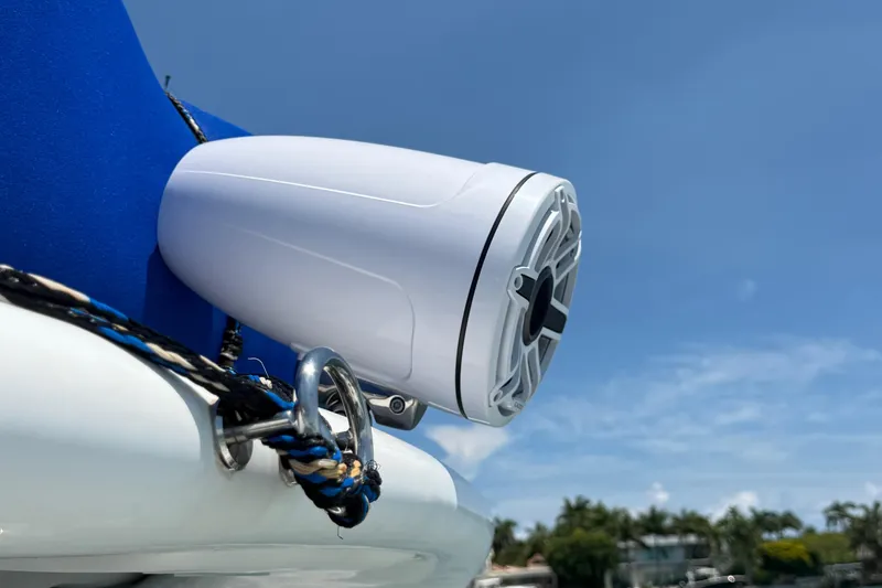 Slide: The Image of White marine speaker on Schaefer 303 boat, 2021 model, against clear blue sky. - 22