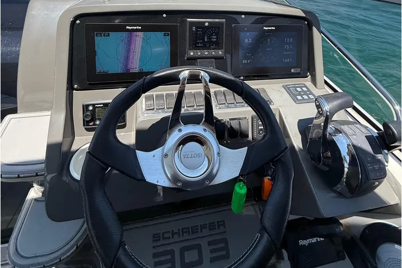 Slide: The Image of Steering console of 2021 Schaefer 303 boat with navigation displays and controls. - 23