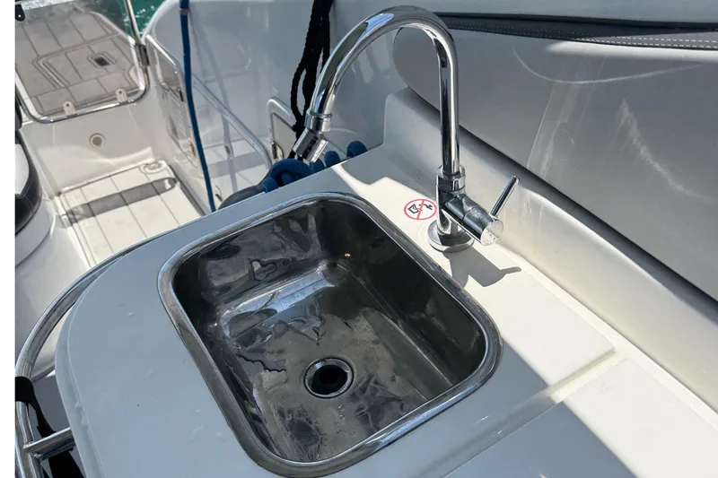 Slide: The Image of Stainless steel sink and faucet on 2021 Schaefer 303 boat deck. - 26