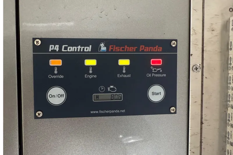 Slide: The Image of Control panel of Fischer Panda P4 with indicators for override, engine, exhaust, and oil pressure. - 29