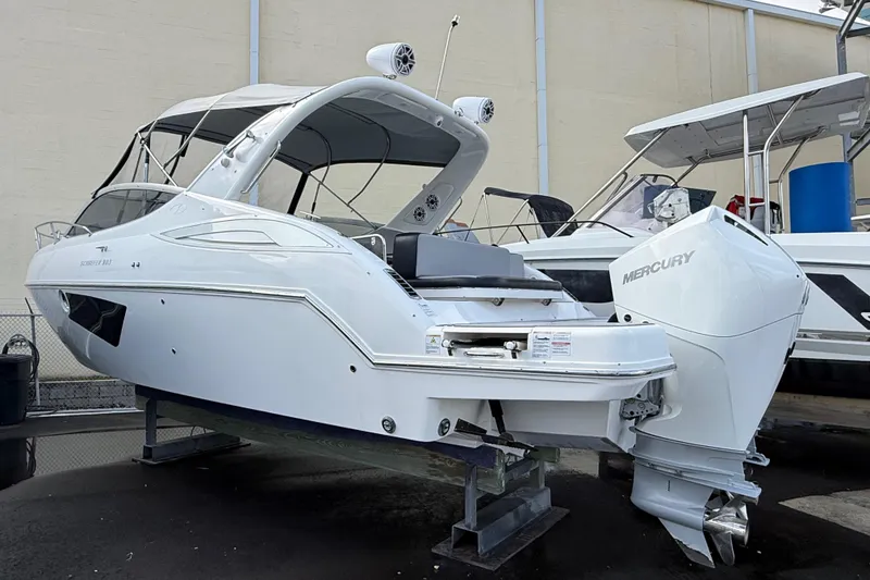 Slide: The Image of Schaefer 303 boat, 2021 model, with Mercury engine, displayed on a stand. - 30