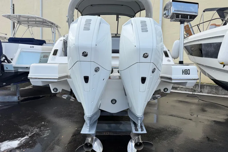 Slide: The Image of Schaefer 303 boat, 2021 model, featuring dual outboard engines in a marina setting. - 34