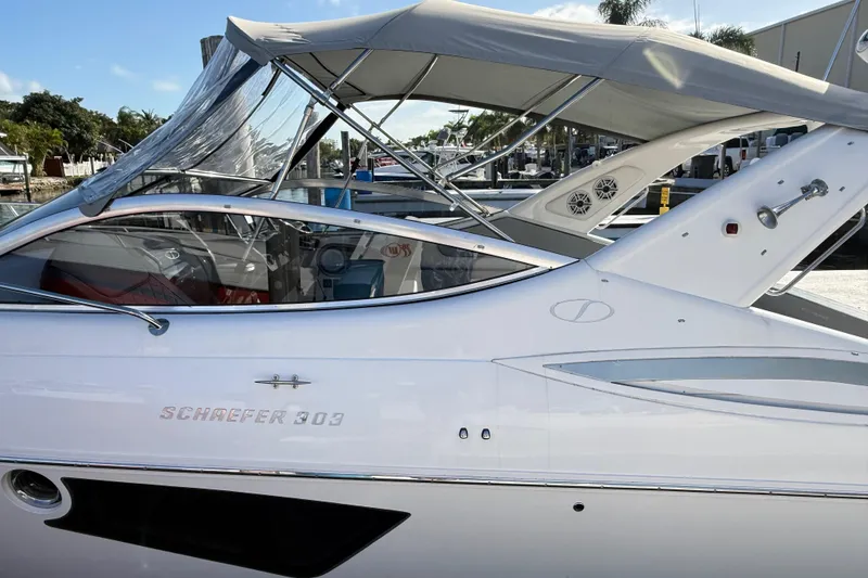 Slide: The Image of Schaefer 303 boat, 2021 model, docked with canopy and sleek design. - 7