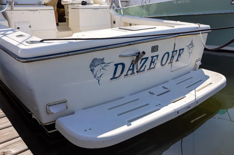 Slide: The Image of 1997 Tiara Yachts 3500 Express boat named "Daze Off" docked at marina. - 11