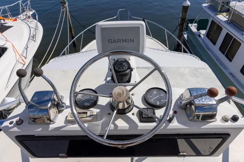 Slide: The Image of 1997 Tiara Yachts 3500 Express helm with Garmin navigation, docked at marina. - 16