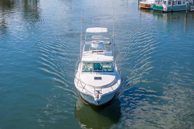 Slide: The Image of 1997 Tiara Yachts 3500 Express cruising on calm waters. - 2