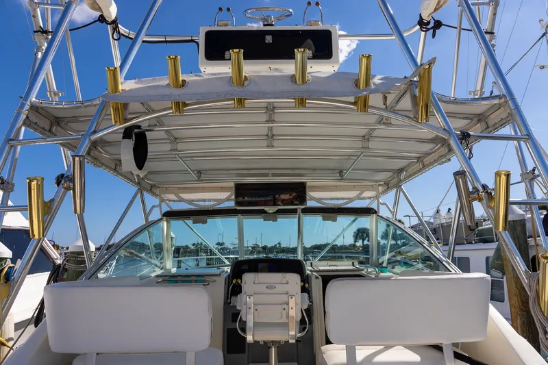 Slide: The Image of 1997 Tiara Yachts 3500 Express cockpit with fishing rod holders and helm station. - 20