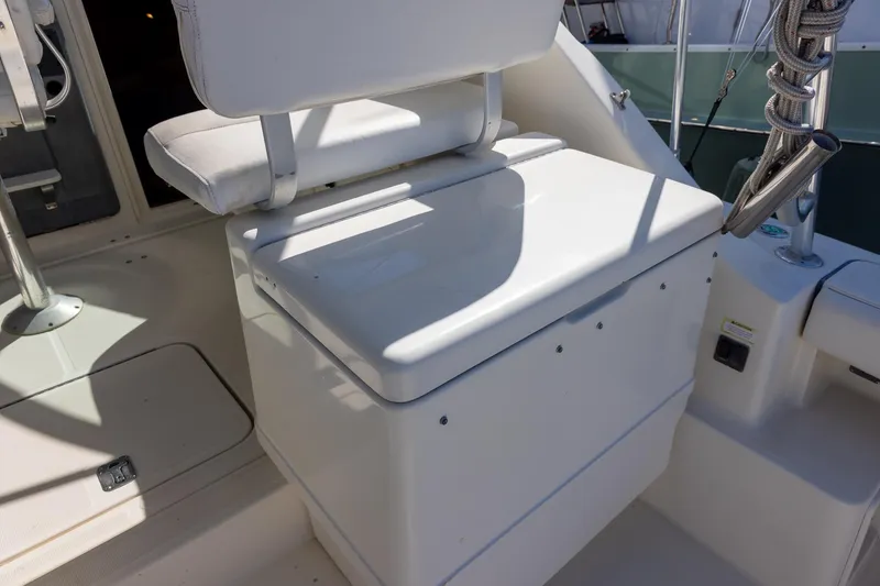 Slide: The Image of 1997 Tiara Yachts 3500 Express cockpit seating and helm area in sunlight. - 30