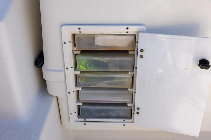Slide: The Image of Storage compartment with tackle boxes on a 1997 Tiara Yachts 3500 Express. - 34