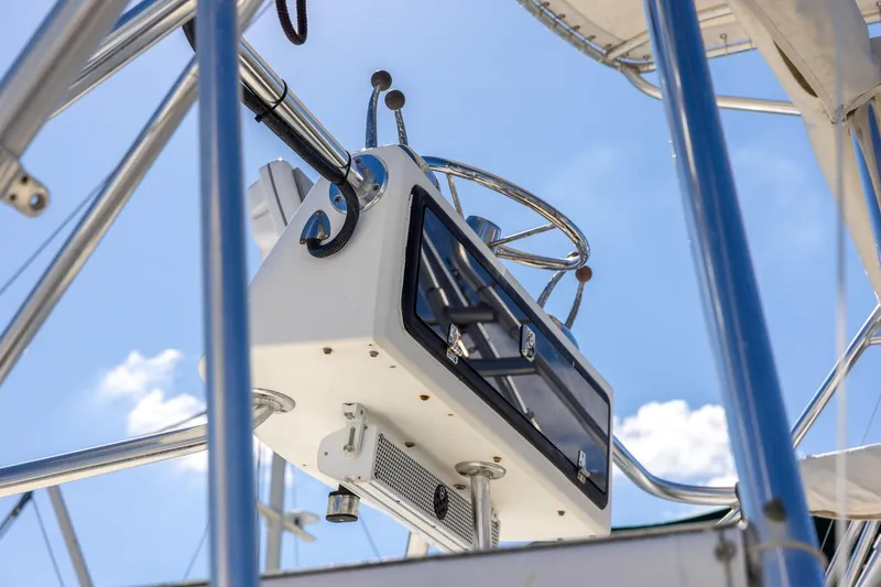 Slide: The Image of 1997 Tiara Yachts 3500 Express helm station with steering wheel, viewed from below. - 36