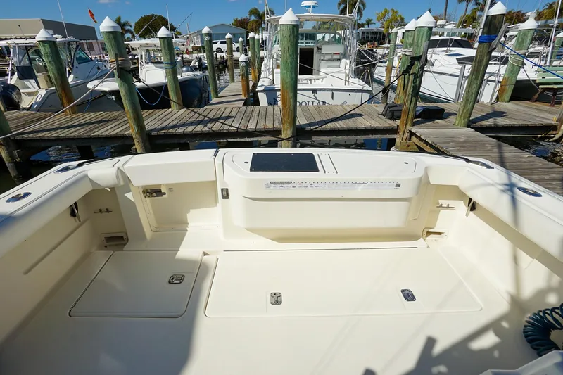 Slide: The Image of 1997 Tiara Yachts 3500 Express at marina dock, showcasing spacious deck area. - 40