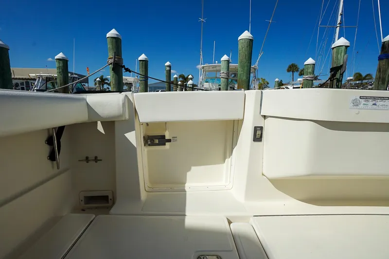 Slide: The Image of 1997 Tiara Yachts 3500 Express boat interior with docked marina view. - 43