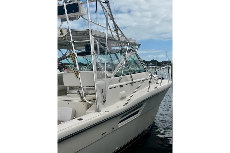 Slide: The Image of 1997 Tiara Yachts 3500 Express boat docked, featuring sleek design and sturdy railings. - 44