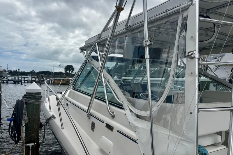 Slide: The Image of 1997 Tiara Yachts 3500 Express docked, featuring sleek design and clear canopy. - 45