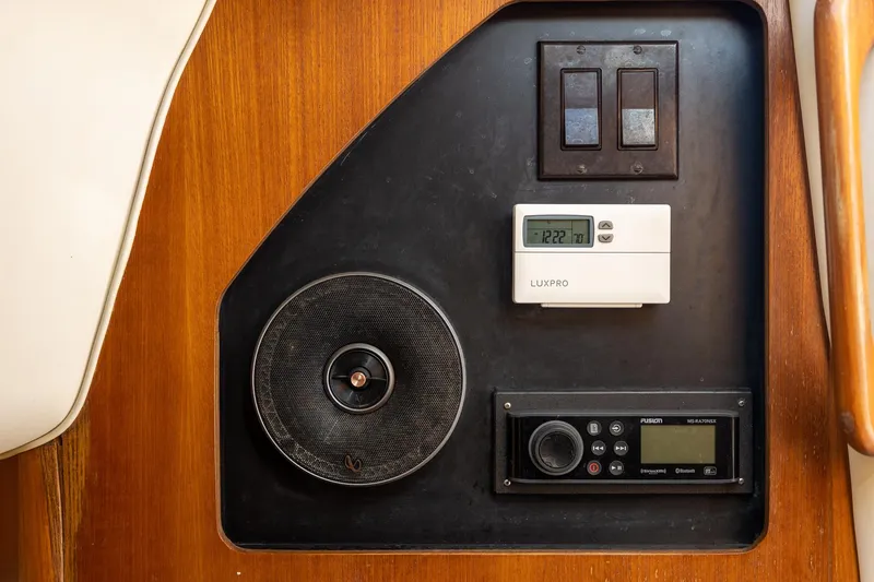 Slide: The Image of Control panel on 1997 Tiara Yachts 3500 Express with speaker, thermostat, and radio. - 52