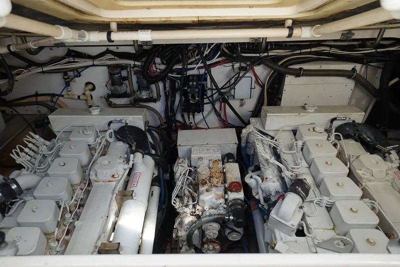 Slide: The Image of Engine room of a 1997 Tiara Yachts 3500 Express, showcasing dual engines and wiring. - 53