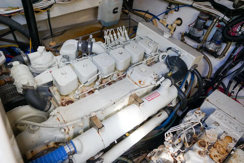 Slide: The Image of Engine room of a 1997 Tiara Yachts 3500 Express, showcasing mechanical components and wiring. - 55