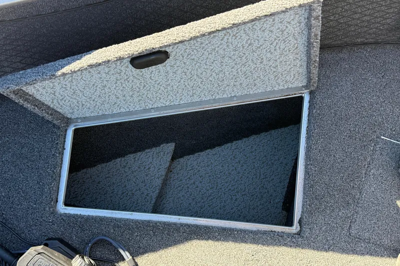 Slide: The Image of Open storage compartment on 2020 Lund 1875 Impact XS boat, featuring carpeted interior. - 14