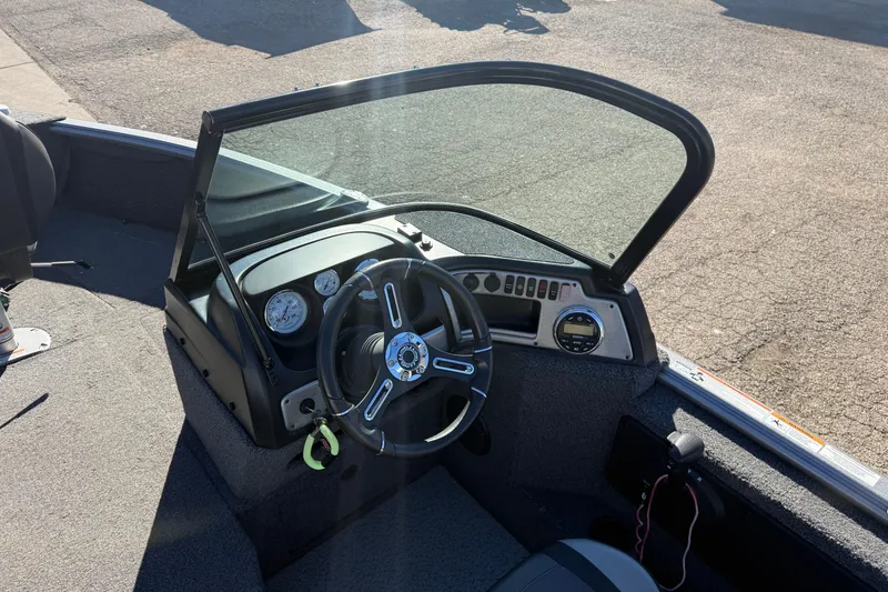 Slide: The Image of 2020 Lund 1875 Impact XS boat dashboard with steering wheel and gauges. - 19