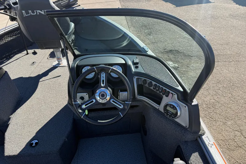 Slide: The Image of 2020 Lund 1875 Impact XS boat dashboard with steering wheel and controls. - 20