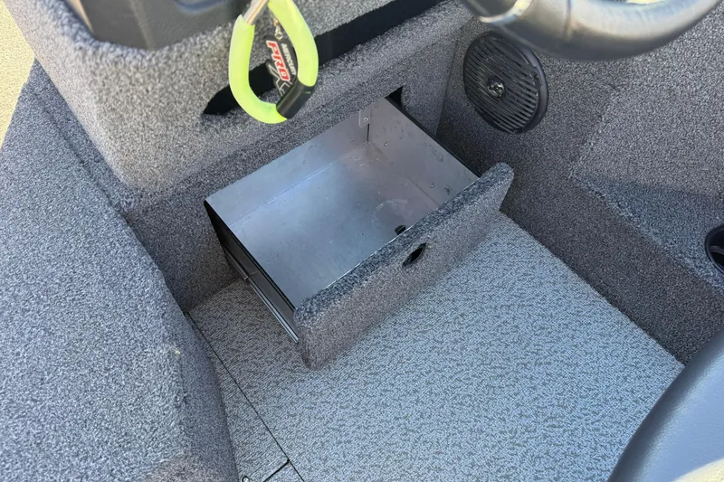 Slide: The Image of 2020 Lund 1875 Impact XS boat interior with open storage compartment and speaker. - 21