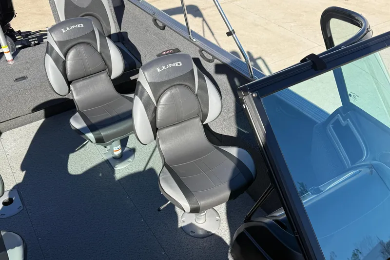 Slide: The Image of 2020 Lund 1875 Impact XS boat interior with two black and gray seats. - 22