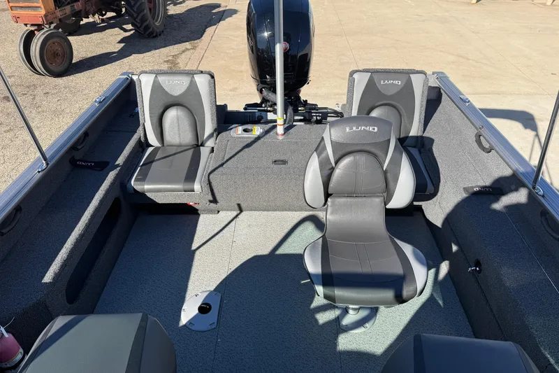 Slide: The Image of 2020 Lund 1875 Impact XS boat interior with gray seating and motor. - 27