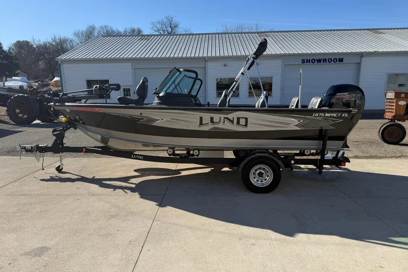 Slide: The Image of 2020 Lund 1875 Impact XS boat on trailer outside showroom. - 4
