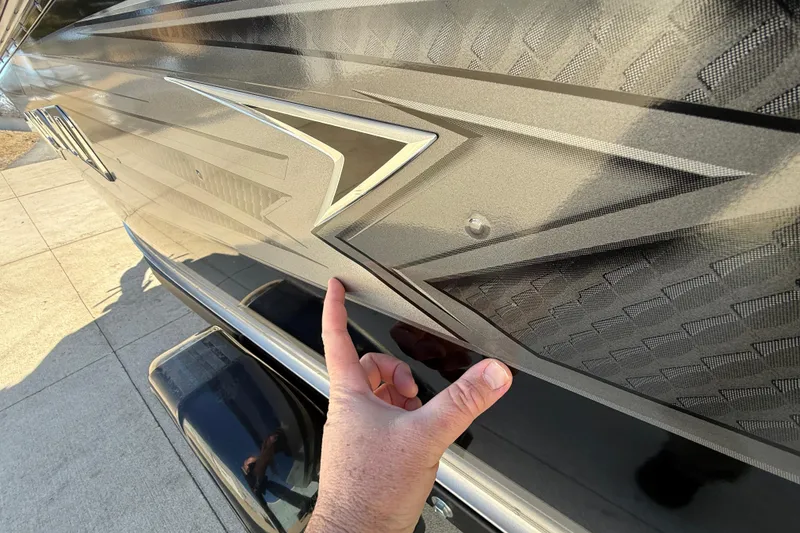 Slide: The Image of Hand pointing at 2020 Lund 1875 Impact XS boat's detailed exterior design. - 42