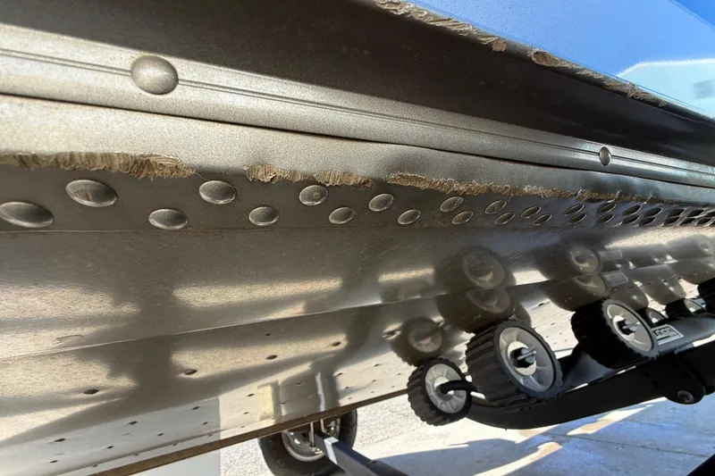 Slide: The Image of Close-up of 2020 Lund 1875 Impact XS boat hull with visible wear and rivets. - 43