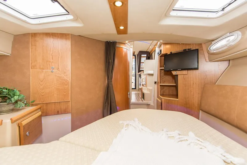 Slide: The Image of Manufacturer Provided Image: Interior of 2022 Cutwater C-30 Sedan boat with cozy bedroom and modern amenities. - 12