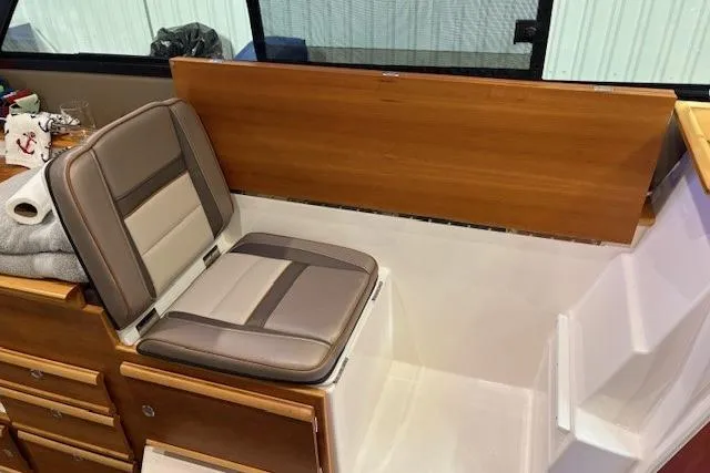 Slide: The Image of 2022 Cutwater C-30 Sedan interior with cushioned seating and wooden cabinetry. - 16