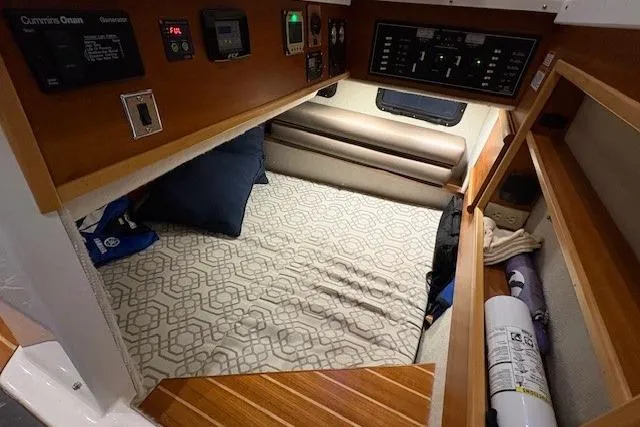 Slide: The Image of 2022 Cutwater C-30 Sedan cabin interior with bed, control panels, and wooden accents. - 19