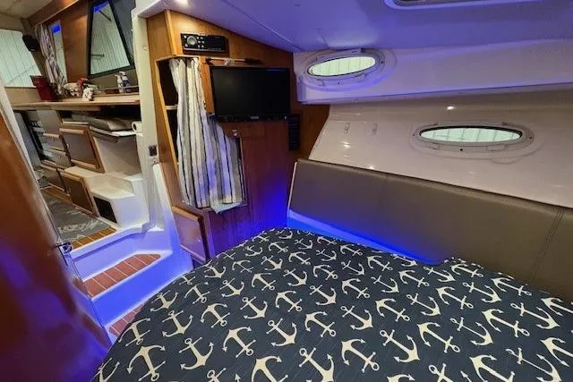 Slide: The Image of Interior of 2022 Cutwater C-30 Sedan with nautical-themed bedding and modern amenities. - 21
