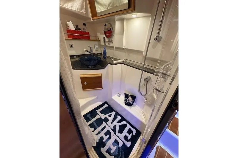 Slide: The Image of 2022 Cutwater C-30 Sedan bathroom with modern fixtures and "Lake Life" mat. - 23