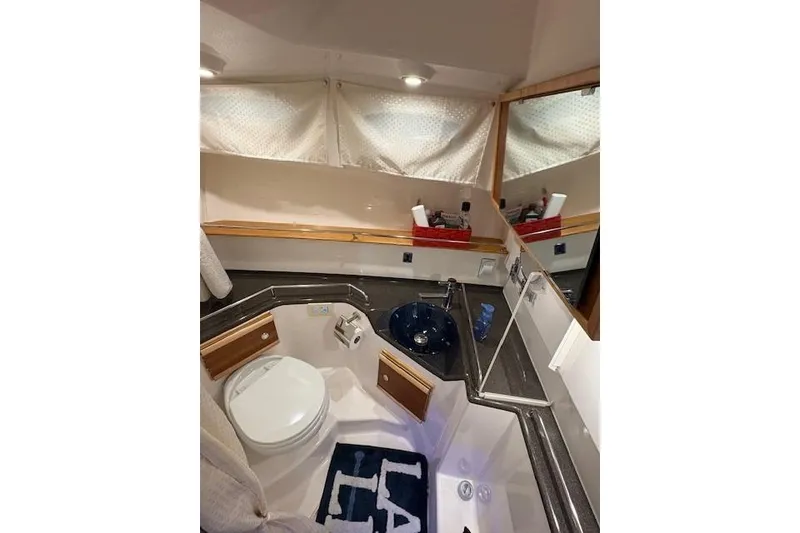 Slide: The Image of Bathroom interior of 2022 Cutwater C-30 Sedan with modern fixtures and compact design. - 24