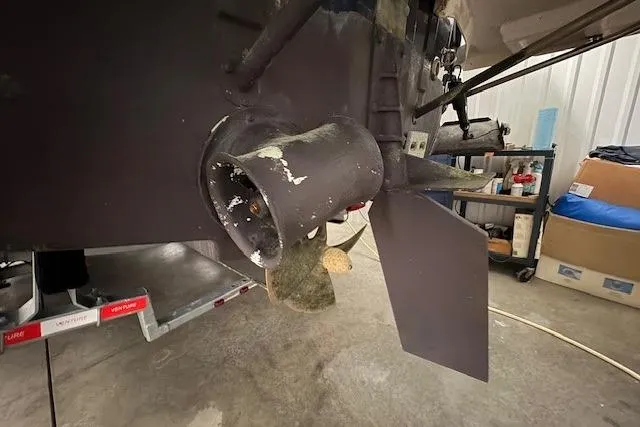 Slide: The Image of 2022 Cutwater C-30 Sedan boat propeller and rudder in a workshop setting. - 28