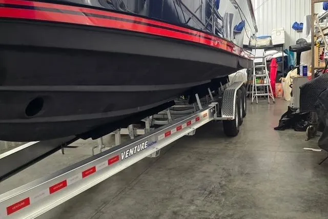 Slide: The Image of 2022 Cutwater C-30 Sedan boat on Venture trailer in a garage setting. - 3