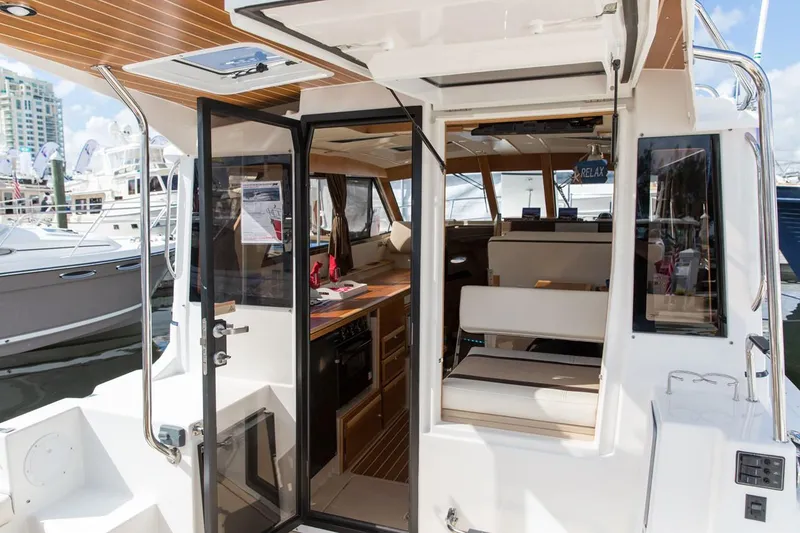 Slide: The Image of Manufacturer Provided Image: 2022 Cutwater C-30 Sedan interior view with open doors at marina. - 5