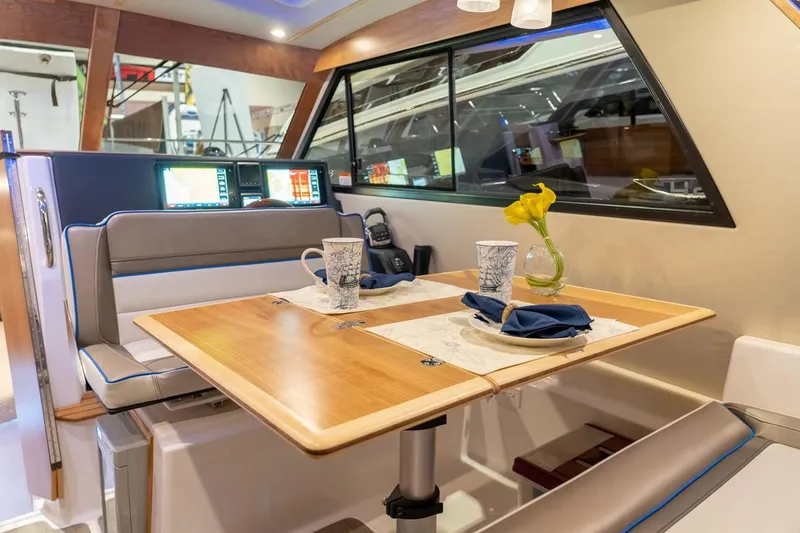 Slide: The Image of Manufacturer Provided Image: Interior of 2022 Cutwater C-30 Sedan with dining table and seating area. - 7