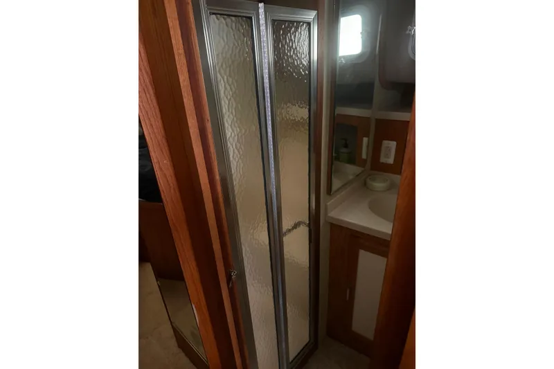 Slide: The Image of 1987 Mainship 36 Nantucket Sedan bathroom with shower and sink area. - 11